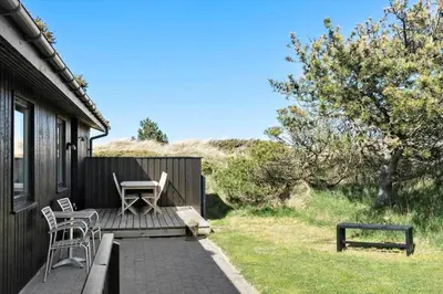 a patio with two chairs and a table and a bench at BL1408-Pandrup-Hunetorp-Klitvej-243 in Pandrup