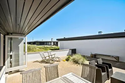 a patio with chairs and tables on a roof at BL1398-Pandrup-Rodhus-Klitvej-135 in Pandrup