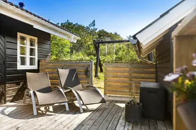 a group of chairs sitting on a wooden deck at BL1758-Saltum-Porsevej-23 in Saltum