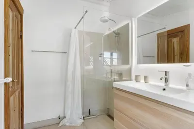 a white bathroom with a shower and a sink at BL1758-Saltum-Porsevej-23 in Saltum