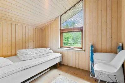 a small room with two beds and a window at BL160-Blokhus-Bag-Hojen-68 in Blokhus