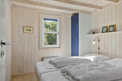 two beds in a room with a window at BL152-Saltum-Kvansletten-33 in Saltum