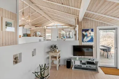a living room with a television and a dining room at BL1047-Saltum-Bag-Havstokken-2-A in Saltum