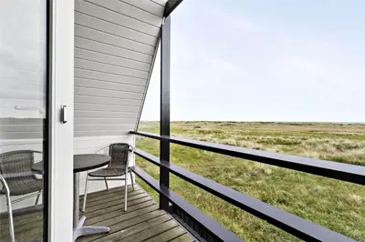 a porch with a table and chairs and a view at BL1193-Pandrup-Narhvalen-14 in Pandrup