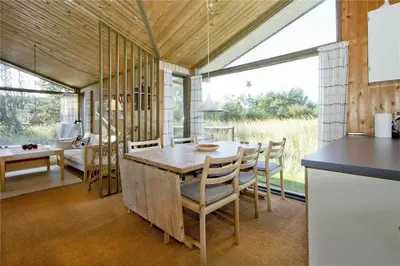 a kitchen and dining room with a table and chairs at BL363-Saltum-Nyborgvej-4 in Saltum