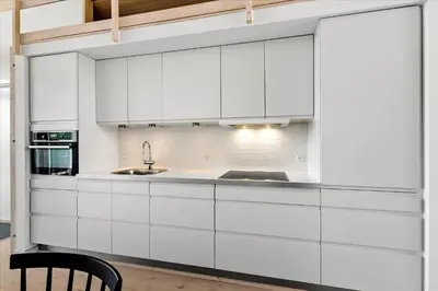 a kitchen with white cabinets and a sink at BL540-Saltum-Trehoje-9 in Saltum