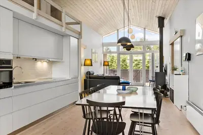 a kitchen and dining room with a table and chairs at BL540-Saltum-Trehoje-9 in Saltum