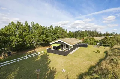 a small house with a grass roof on a field at BL1066-Pandrup-Rodhus-Skolevej-17 in Pandrup