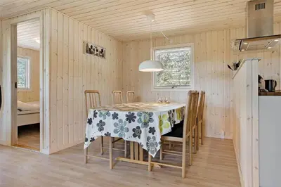 a kitchen and dining room with a table and chairs at BL1066-Pandrup-Rodhus-Skolevej-17 in Pandrup