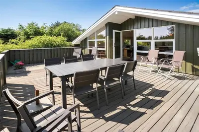 a wooden deck with a table and chairs on it at BL1625-Saltum-Fladen-Grund-8 in Saltum