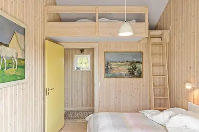 a bedroom with a bunk bed and a horse on the wall at BL137-Blokhus-Pirupshvarre-Klit-6 in Blokhus