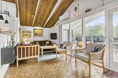 a living room with chairs and a couch and a tv at BL1379-Blokhus-Saetergaardsvej-8 in Blokhus