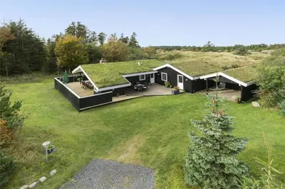 a house with a green roof with a yard at BL1379-Blokhus-Saetergaardsvej-8 in Blokhus