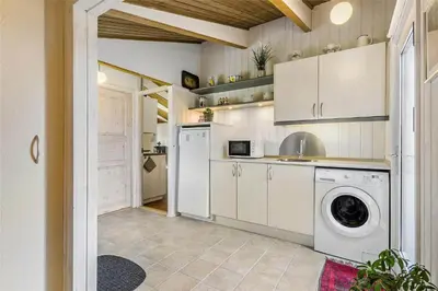a kitchen with a washing machine and a washer at BL1379-Blokhus-Saetergaardsvej-8 in Blokhus