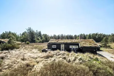 an old house with a grass roof in a field at BL112-Saltum-Kvansletten-20 in Saltum
