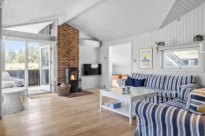 a living room with a couch and a fireplace at BL112-Saltum-Kvansletten-20 in Saltum