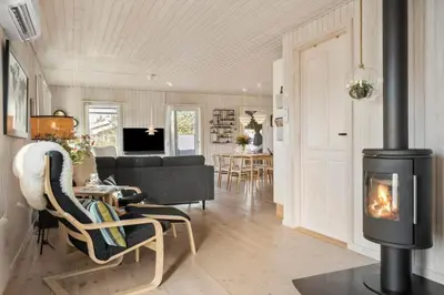 a living room with a fireplace and a couch at BL1502-Blokhus-Graevlingevej-3 in Blokhus