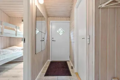 a room with a hallway with a door and a bed at BL180-Blokhus-Soren-Petersvej-22 in Blokhus