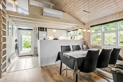 a kitchen and dining room with a table and chairs at BL180-Blokhus-Soren-Petersvej-22 in Blokhus
