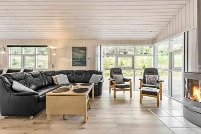 a living room with a couch and a fireplace at BL180-Blokhus-Soren-Petersvej-22 in Blokhus