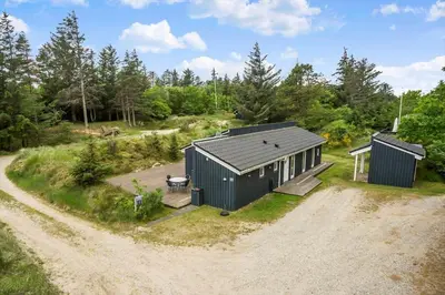 an aerial view of a house with a dirt road at BL180-Blokhus-Soren-Petersvej-22 in Blokhus