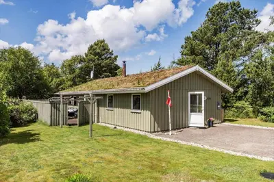 a green house with a grass yard at BL721-Pandrup-Rodhus-Skolevej-32 in Pandrup