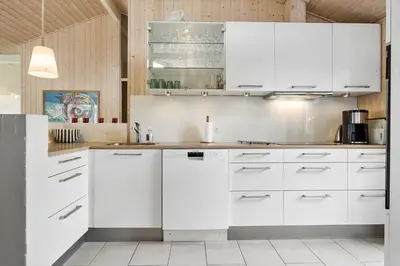 a kitchen with white cabinets and white appliances at BL325-Blokhus-Lyngvej-11 in Blokhus