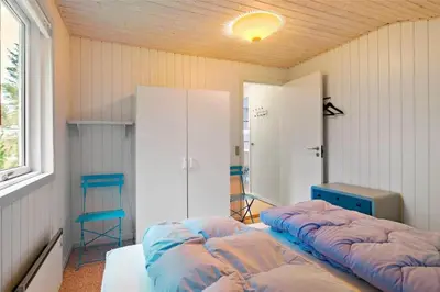 a room with two beds in a room with a window at BL488-Pandrup-Akelejevej-10 in Pandrup
