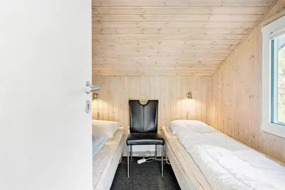 a room with a chair and a bed in it at BL714-Saltum-Ornebjergvej-24 in Saltum