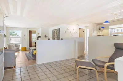 a kitchen and living room with white walls and chairs at BL1073-Blokhus-Egonsvej-10 in Blokhus