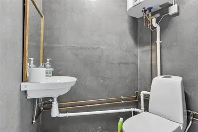 a bathroom with a white toilet and a sink at BL1540-Blokhus-Jens-Baerentsvej-14 in Blokhus