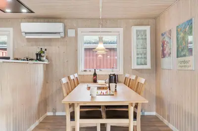 a kitchen with a wooden table and chairs at BL1682-Pandrup-Rodhus-Skolevej-24 in Pandrup