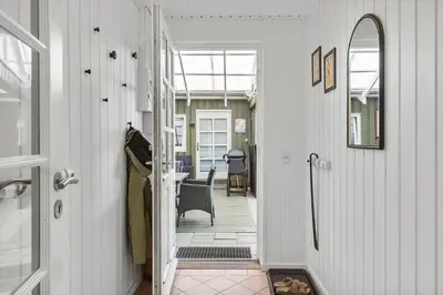 a hallway with a door leading to a dining room at BL1216-Blokhus-Gyvelvej-13 in Blokhus