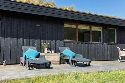 a group of chairs on a deck next to a building at BL188-Saltum-Kordalssletten-3 in Saltum