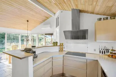 a kitchen with white cabinets and a wooden ceiling at BL188-Saltum-Kordalssletten-3 in Saltum