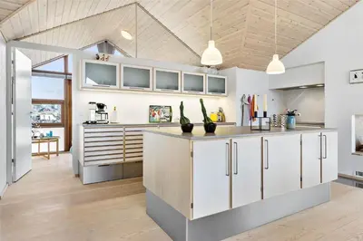 a kitchen with white cabinets and a counter top at BL1733-Blokhus-Dahl-Iversensvej-5 in Blokhus