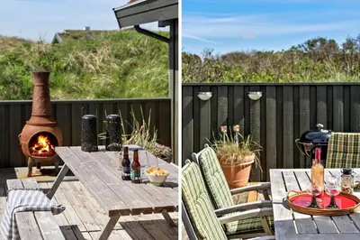 a deck with a picnic table and a fireplace at BL1755-Saltum-Karen-Mariesvej-57 in Saltum