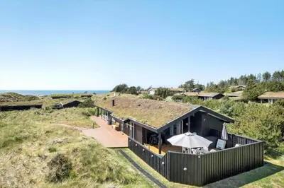 a house on the beach with a grass roof at BL1386-Saltum-Kordalslien-7 in Saltum