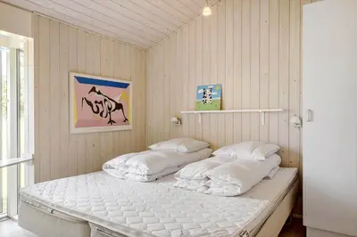 a bedroom with two white beds in it at BL1386-Saltum-Kordalslien-7 in Saltum