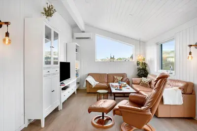 a living room with a couch and a tv at BL332-Saltum-Svendborgvej-18 in Saltum