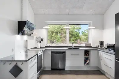 a white kitchen with a sink and a window at BL1266-Pandrup-Rodhusparken-58 in Pandrup
