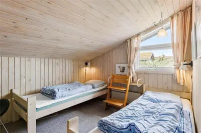 a bedroom with two beds and a window at BL1281-Saltum-Foraarsvangen-8 in Saltum