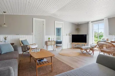 a living room with a couch and a table at BL1640-Blokhus-Solbakkevej-2 in Blokhus