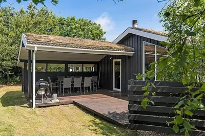 a house with a wooden deck with a gazebo at BL257-Pandrup-Rodhus-Skolevej-44 in Pandrup
