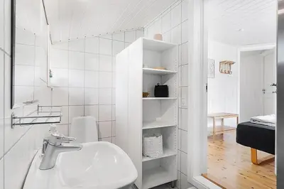 a white bathroom with a sink and a toilet at BL257-Pandrup-Rodhus-Skolevej-44 in Pandrup