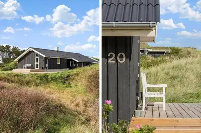 a house with a white chair sitting on a deck at BL119-Blokhus-Egebaeksvej-20 in Blokhus