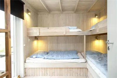 two bunk beds in a room with a window at BL406-Saltum-Graabakken-57 in Saltum