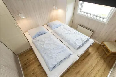 a large bed in a small room with a window at BL406-Saltum-Graabakken-57 in Saltum