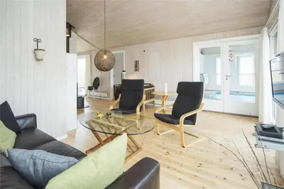 a living room with a couch and chairs and a table at BL406-Saltum-Graabakken-57 in Saltum