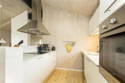 a white kitchen with a sink and a stove at BL406-Saltum-Graabakken-57 in Saltum